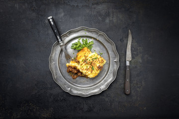 English shepherds pie as top-view on a pewter plate with copy space