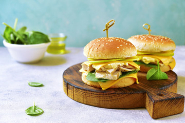 Healthy homemade cheeseburger with boiled chicken, apple and spinach.
