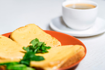 Breakfast of cheese sandwich and cup of coffee