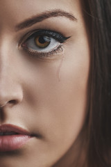 Fototapeta premium Closeup photo from a beautiful young sad woman crying