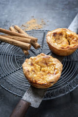 Traditional Portuguese pasteis de nata as close-up on a cooling rack