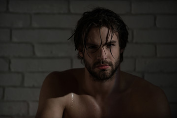sexy man with wet hair, muscular body in bath, shower