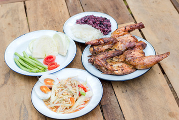 Grilled chicken, Papaya salad or Som Tum, Thai style famous local the eastern delicious food of Thailand.