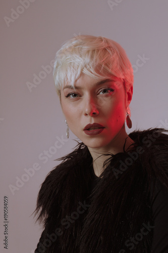 Beautiful Blonde Girl With Short Hair And Makeup In A Black Fur