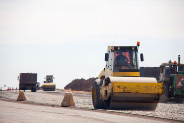 the road rollers working on the new road construction site asphalt compactor