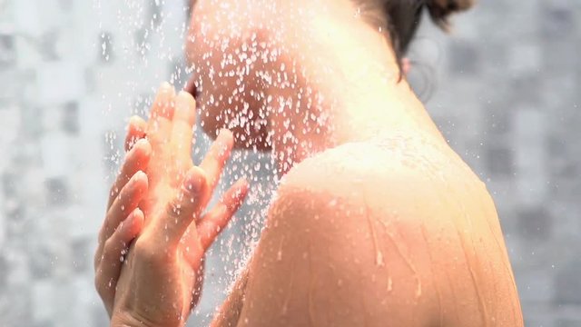 Woman washing her body under shower, super slow motion, 240fps
