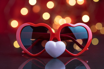 Valentines heart shape eyeglasses with pink ceramic decoration heart and party light bokeh...
