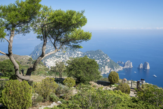 Bright scenic view of the iconic Faraglioni rocks from the cliffside trail on the Mediterranean island of Capri, Italy