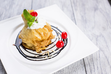 ried icecream with whipped cream and cherry on top and chocolate dressing