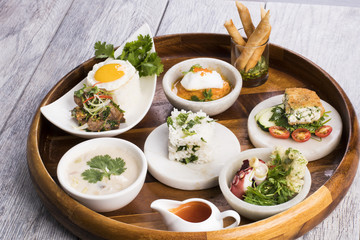 Assorted Thai food on wooden platter
