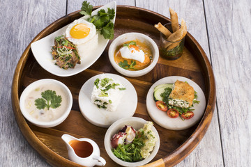 Assorted Thai food on wooden platter