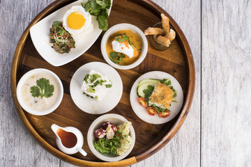 Assorted Thai food on wooden platter