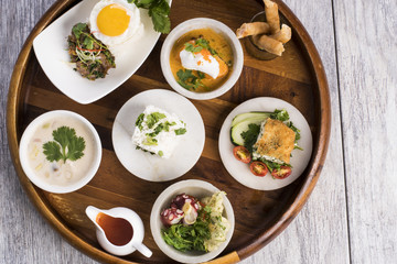 Fototapeta na wymiar Assorted Thai food on wooden platter