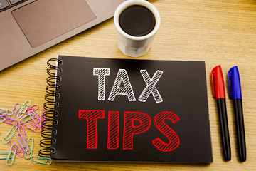 Handwriting Announcement text showing Tax Tips. Business concept for Taxpayer Assistance Refund Reimbursement written on notebook book on the wooden background in the Office with laptop coffee