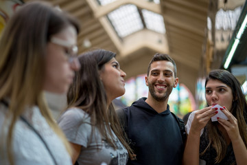 Friends hang out at fruit market