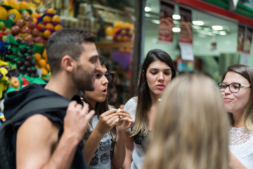 Friends Eating and Having Fun on Fruit Market in Municipal Market (Mercado Municipal) in Sao Paulo,...