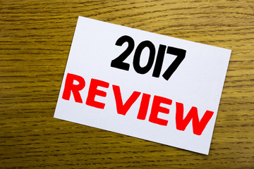 2017 Review. Business concept for Annual Summary Report written on sticky note, wooden wood background with copy space.