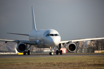 Close up passenger plane rides after landing in sunny day, front view/ Airplane turns on runway/ Engine heat behind the airplane/ Very hot air behind the aircraft engine, blurred background