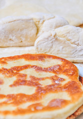Ready fried wheat pitas and raw yeast dough