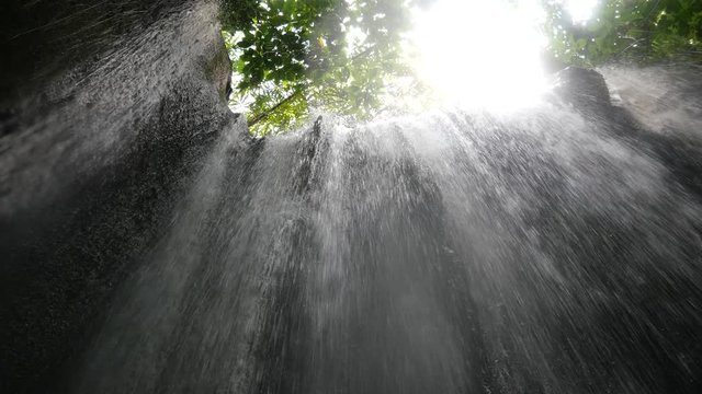 Bali, Indonesia-September 18, 2017: Tukad Cepung Waterfall is a hidden waterfall in Bali. Magnificent and noble waterfall is surrounded by great nature landscape.