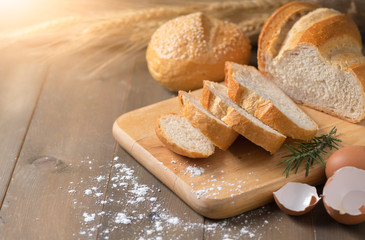 Fototapeta na wymiar Homemade bread sliced on wood block
