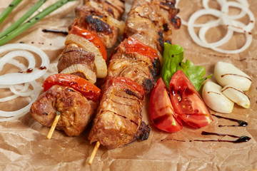 Pork meat kebab with sauces and vegetables