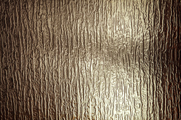 sunlight on the surface of corrugated glass