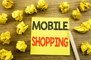 Fototapeta premium Word, writing Mobile Shopping. Business concept for Cellphone online order written on sticky note paper on the wooden background. Folded yellow papers on the background