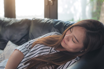 Closeup image of a beautiful asian woman taking a nap during daytime with feeling relaxed