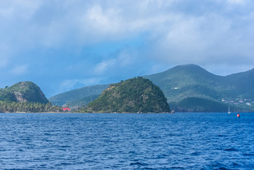 Guadeloupe, beautiful seascape of the Saintes islands, typical houses and sailboats in the marina
