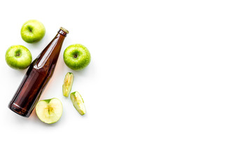 Apple cider. Low-alcoholic beveradge in dark bottle on white background top view copy space