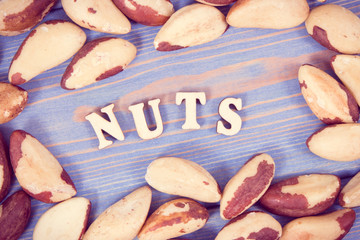 Vintage photo, Inscription nuts and brasil nuts containing natural minerals and vitamin on old boards