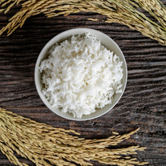 Rice in bowl on wooden desk with spike rice.