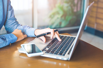 Woman hand working on laptop in the office.