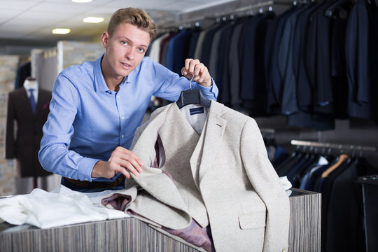 Adult male selling jacket in the store