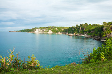 Fototapeta na wymiar beautiful scenery of green hill with blue ocean