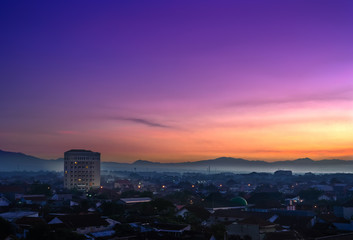 Landmark of Purwokerto city in Banyumas regency, Central Java at dawn before sunrise. Cityscape aerial view in misty morning