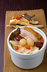 Chicken and herb soup in pot, Chinese food style.