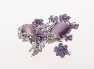 brooch with different gems on background.