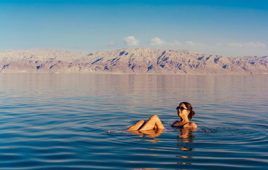 Girl is relaxing and swimming in the water