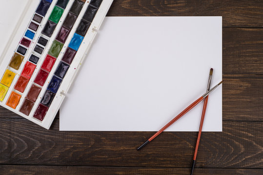 Paints, pencils and brushes on wooden to a floor. Image preprocessing