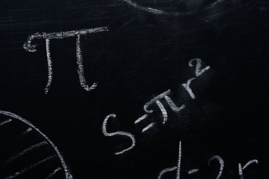 PI day concept. The formula for the area of a circle written on the blackboard