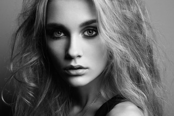 Portrait of young beautiful girl with blonde hair. Fashion photo. Hairstyle. Make up. Vogue Style. Black and white photo.