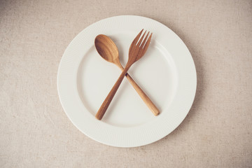 white plate with spoon and fork, Intermittent fasting concept, ketogenic diet, weight loss,...