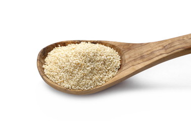 Pile sesame seeds in wooden spoon isolated on white background