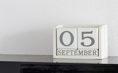 White block calendar present date 5 and month September