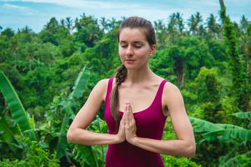 Creating Namaste. Woman putting her palms together on her chest area.