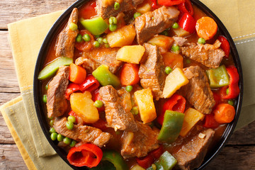 Philippine cuisine: kaldereta beef with vegetables close-up. horizontal top view