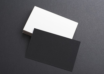 Black and white business card on black background. Mockup.