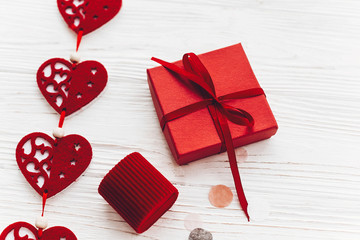 stylish red hearts with gift on white rustic wooden background flat lay. space for text. happy valentines day present. valentine's day concept. greeting card. birthday or wedding